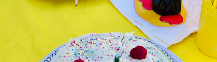 Avas emoji rainbow cake topped with rasberries